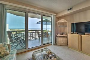 a living room with a television and a view of the ocean at Oceanfront Resort, Year-Round Pools, Private Beach in Wildwood Crest