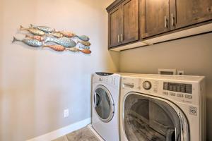 a laundry room with a washing machine with fish on the wall at Modern Huntsville Resort Retreat with Deck and Hot Tub in Huntsville