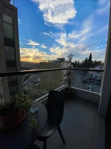 a balcony with a table and a view of a city at Nu Fifty Two in Amman