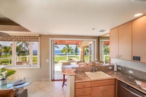 a kitchen with a view of the ocean at Keauhou Gardens Penthouse 22B at Kona Coast Resort in Kailua-Kona
