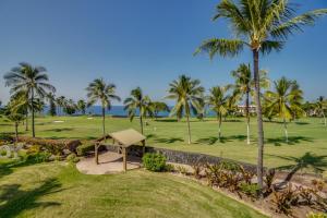 a view of a golf course with palm trees at Keauhou Gardens Penthouse 22B at Kona Coast Resort in Kailua-Kona