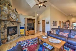 a living room with a couch and a fireplace at Pagosa Springs Home with Deck and Grill, Walk to Town! in Pagosa Springs