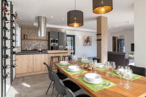a dining room and kitchen with a table and chairs at Spacious New design Villa Vitis Vitae, private pool ,1400m2 garden , Central Istria in Svetvinčenat