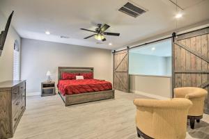 a bedroom with a red bed and a ceiling fan at Upscale EaDo Townhome - Walk to BBVA and Local Bars! in Houston