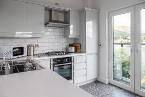a kitchen with white appliances and a large window at The Views in Newcastle