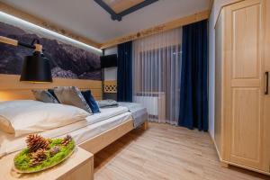 a bedroom with a bed and a bowl of fruit on a table at Willa U GAŁÓW in Poronin