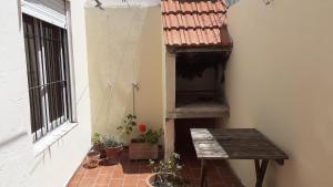 a small balcony with a table and potted plants at Amaneceres en Punta mogotes in Mar del Plata