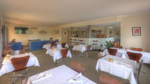 a dining room table with chairs and tables at Country Roads Motor Inn in Goondiwindi