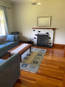 a living room with a coffee table and a fireplace at One Panama in Martinborough