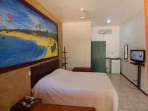 Säng eller sängar i ett rum på Pousada Casa de Taipa