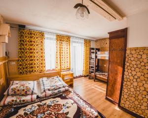 a bedroom with a bed and a pile of logs at Dom wypoczynkowy Stoch Mądry in Zakopane