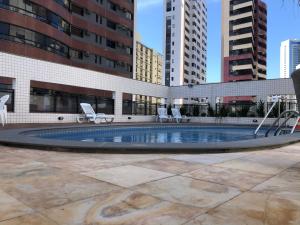 a pool in the middle of a city with buildings at APARTAMENTO EM NATAL III in Natal