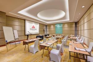 a conference room with tables and chairs and a screen at St Giles Boulevard in Kuala Lumpur