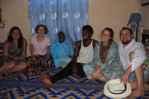 een groep mensen die op een bed zitten bij Moringe Home Stay - Village House in Jambiani