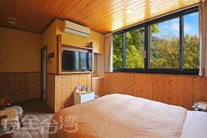 Postel nebo postele na pokoji v ubytování Sun Moon Lake Tan Hsiang Yu B&B