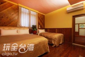 Postel nebo postele na pokoji v ubytování Sun Moon Lake Tan Hsiang Yu B&B