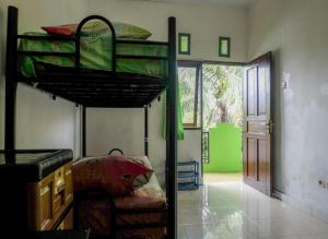 a bedroom with two bunk beds in a room at Umah Hijau Tabanan in Tabanan