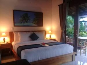 Postel nebo postele na pokoji v ubytování Paraiso Cottage Ubud