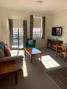 a living room with a couch and a coffee table at Apartments On Grey in Glen Innes