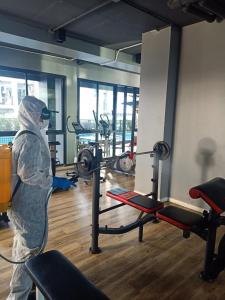 a person standing in a gym with a machine at Interpark Hotel & Residence, Eastern Seaboard Rayong in Ban Phan Sadet Nok