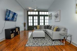 a living room with a couch and a tv at French Quarter Delight 12 in New Orleans