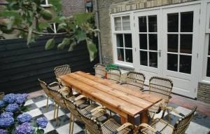 un tavolo e sedie di legno su un patio di Voc Huys a Enkhuizen