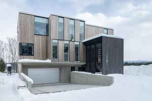 a wooden house in the snow in the snow at Yama no Oto in Furano