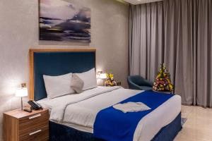 a bedroom with a large bed and a christmas tree at Suha Creek Hotel Apartment, Waterfront Jaddaf, Dubai in Dubai