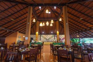 a dining room with tables and chairs in a building at Phi Phi Natural Resort-SHA Extra Plus in Phi Phi Don