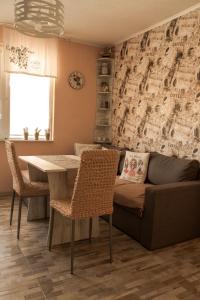 a living room with a couch and a table at Апартамент Fleur in Nesebar