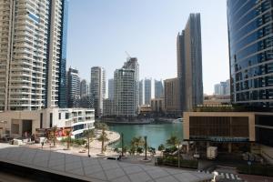 Suha JBR Hotel Apartments في دبي: اطلالة على مدينة بها نهر ومباني