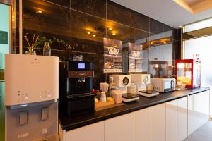a kitchen with a counter with microwaves and appliances at Cheonan A One Hotel in Cheonan