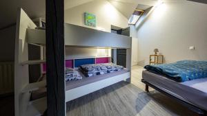 a bedroom with two bunk beds in a room at Domaine de l'Atelier in Soultzmatt