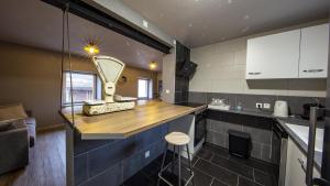 a kitchen with a counter with a mirror on it at Domaine de l'Atelier in Soultzmatt