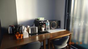 a table with a microwave and a coffee maker on it at Hotel HueStay-KeumHo in Seogwipo