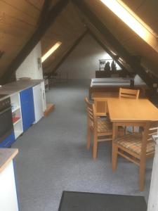 a room with a table and chairs in a attic at Beim Heines in Daun