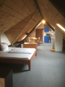 a attic room with two beds and a kitchen at Beim Heines in Daun