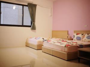 Postel nebo postele na pokoji v ubytování Zhong Xing Lohas Homestay