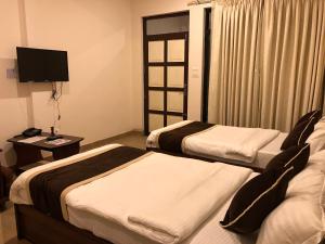 Postel nebo postele na pokoji v ubytování Hotel Satyam