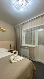 Ένα ή περισσότερα κρεβάτια σε δωμάτιο στο Hotel Sozvezdie Medveditsy