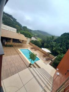 a view of a swimming pool in a house at Pousada Casa do Jova em Raposo RJ 