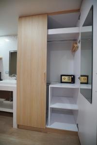 a room with a closet with a radio in it at The Qube fifty Hotel in Bangkok