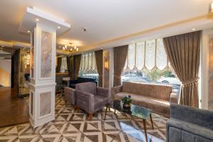 a living room with a couch and chairs and a fireplace at Hotel Yesilpark in Istanbul