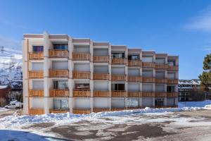 an apartment building with snow on the ground at Vacancéole - Résidence Le Sappey - Les 2 Alpes in Les Deux Alpes