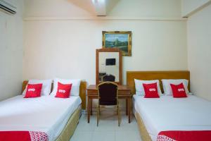a room with two beds with red pillows at SPOT ON 89962 Perfect Class Hotel in Kuala Lumpur
