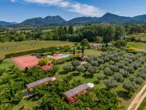 an aerial view of a farm with a pool and trees at Les Piégonnaises - Deux luxueuses roulottes et la cabane en Drôme Provençale in Piégon