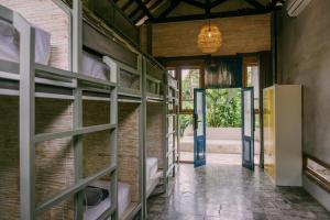 a hallway of a house with doors and shelves at Dormitory at Semadi living in Sukawati