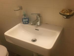 a white sink with a faucet in a bathroom at Petit Appart de Charme Eau chaude solaire Rénovation 2021 Wifi disponible Belvedere 5 in Saint-Luc