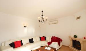 a living room with a white couch and a chandelier at Villa Saint Thomas by Algarve Vacation in Carvoeiro