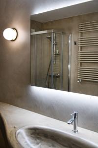 a bathroom with a sink and a mirror at Dimora Fortebraccio in LʼAquila